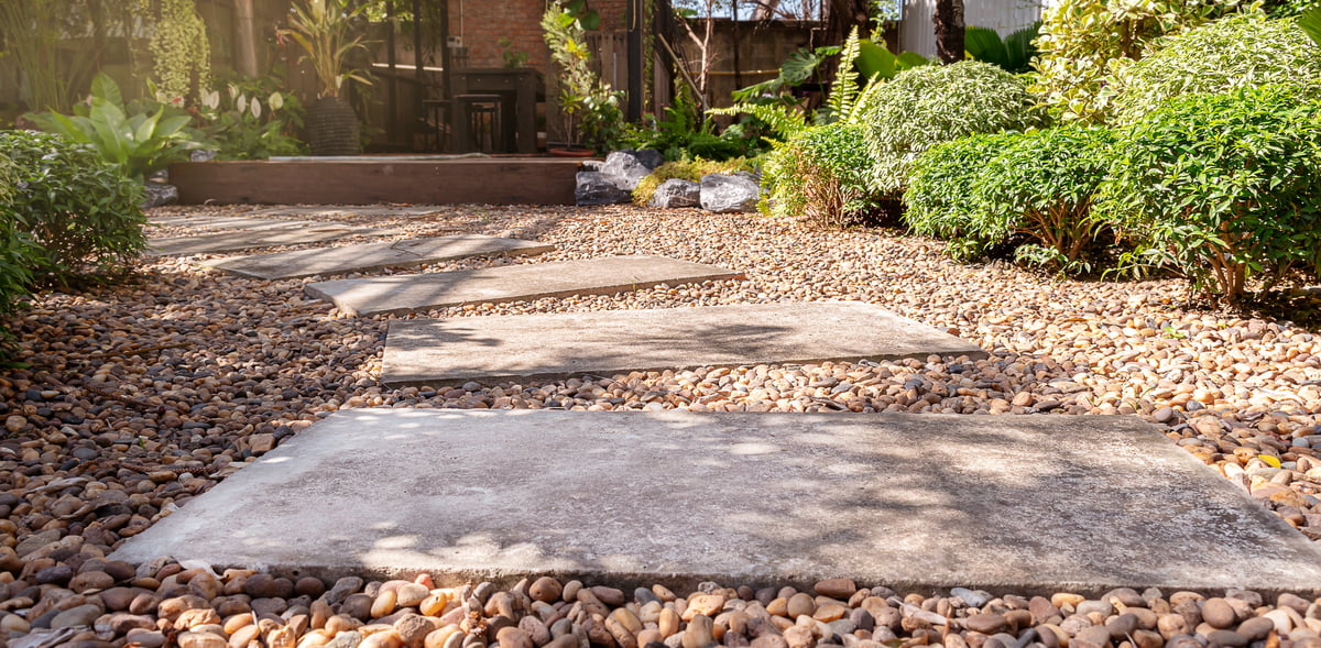 A stone block walkway laid over gravel stone flooring